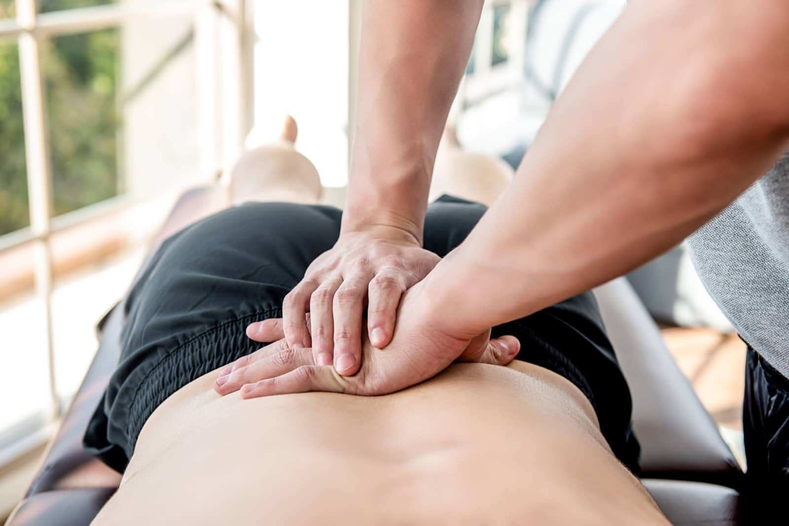 man getting chiropractic adjustment by a chiropractor
