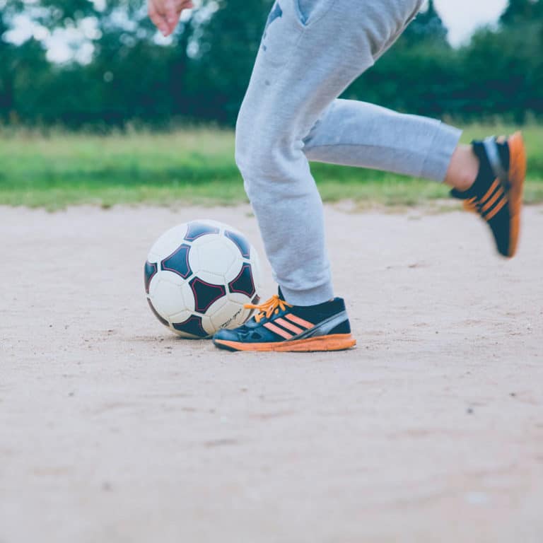 healthy child playing soccer after pediatric chiropractic adjustment